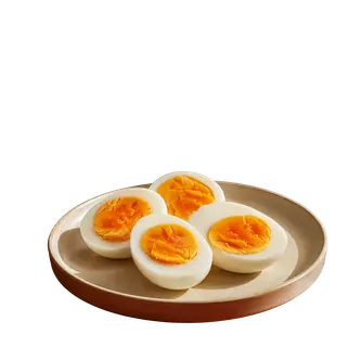 Four halves of hard-boiled eggs with bright orange yolks served on a beige ceramic plate against a plain grey background.