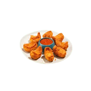 A plate of golden-brown fried momos arranged in a circle around a small blue bowl of red dipping sauce, isolated on a solid grey background.