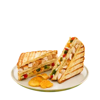 Two halves of a grilled chicken and vegetable sandwich served on a plate with potato chips against a plain grey background.